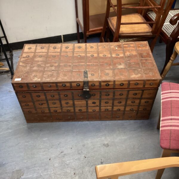 Antique metal lined chest with small drawers and metal banding.