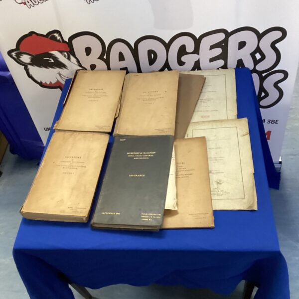 Antique share certificate ledgers with handwritten titles and dates.