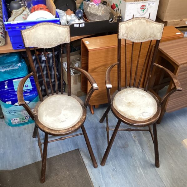 Pair of antique stick back carver chairs with patterned seats.