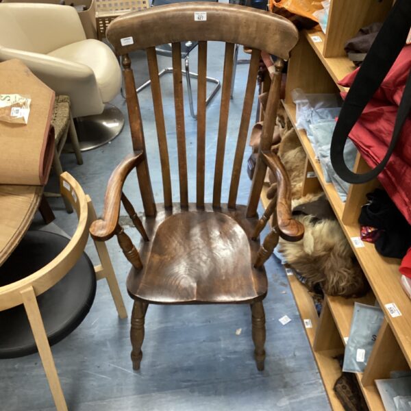 Antique 19th-century Windsor armchair with carved details.