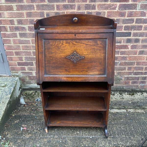 Front view of antique writers bureau with open shelves.
