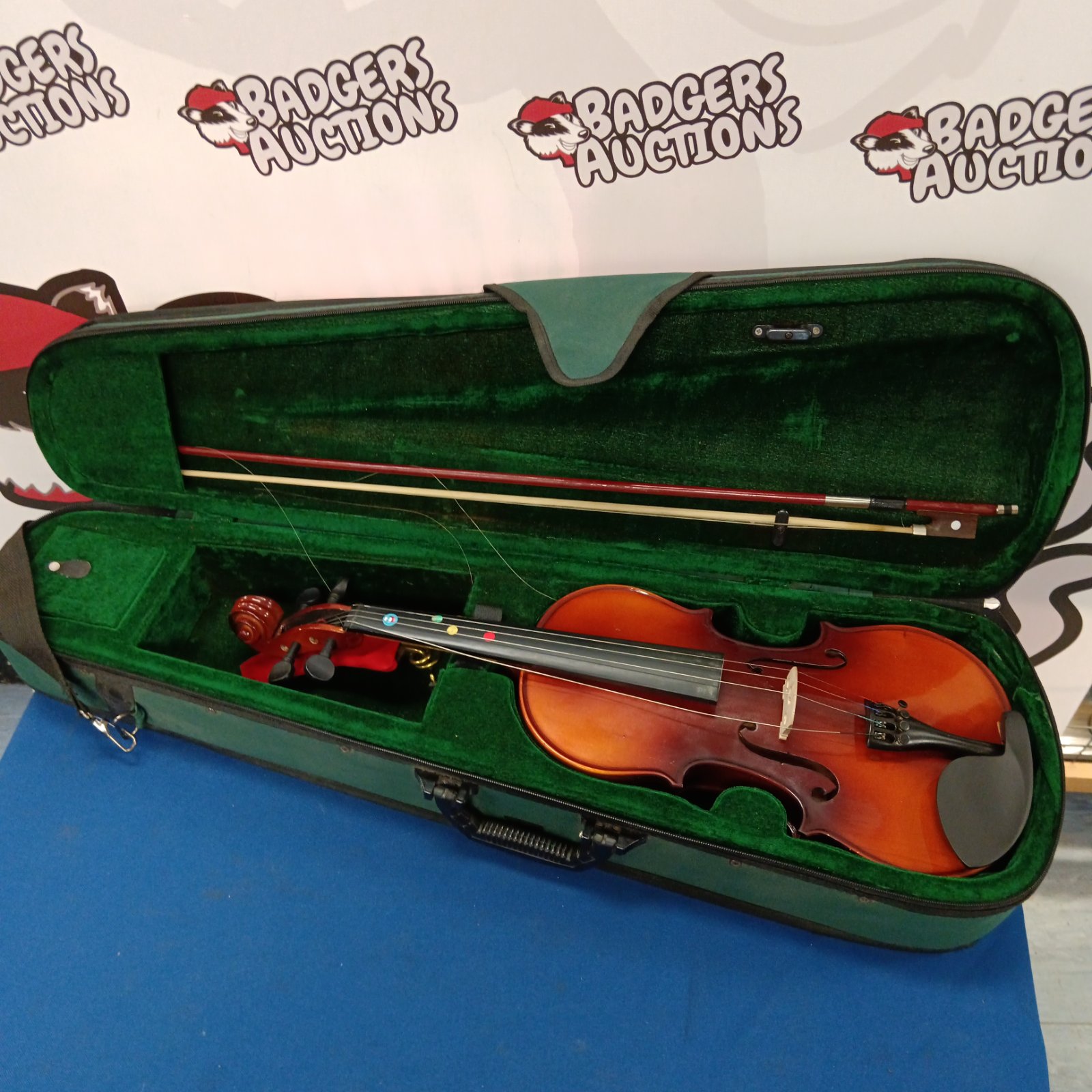 Antique Antoni violin in a green case with bow.