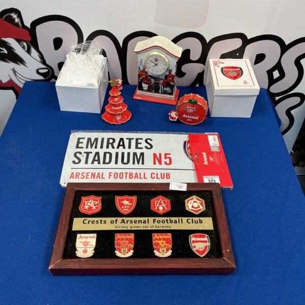 Arsenal FC merchandise collection featuring Emirates Stadium replica and boxed items.