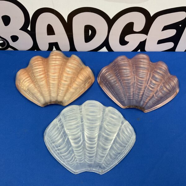 Set of three Art Deco glass clam shells on blue background.