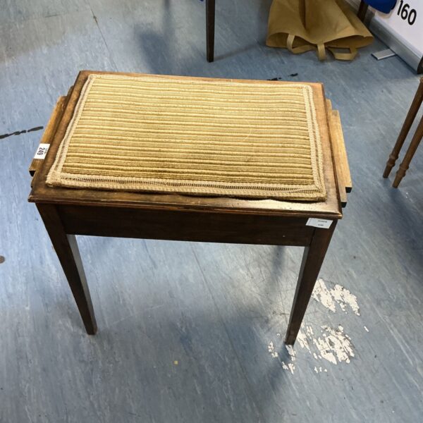 Vintage Art Deco piano stool with beige padded seat and mahogany legs.