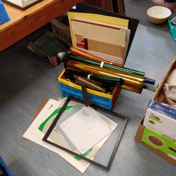 Mixed lot of art materials including frames and paper rolls.