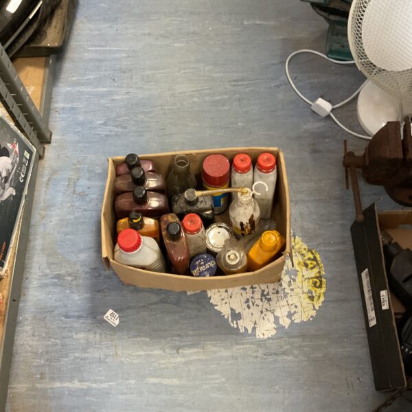 Box of assorted chemicals and car care products.