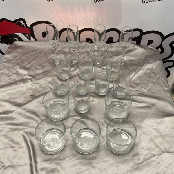 Mixed lot of assorted clear drinking glasses on display.