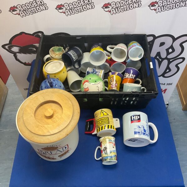 Assorted mugs and pottery lot with bread bin in a crate.