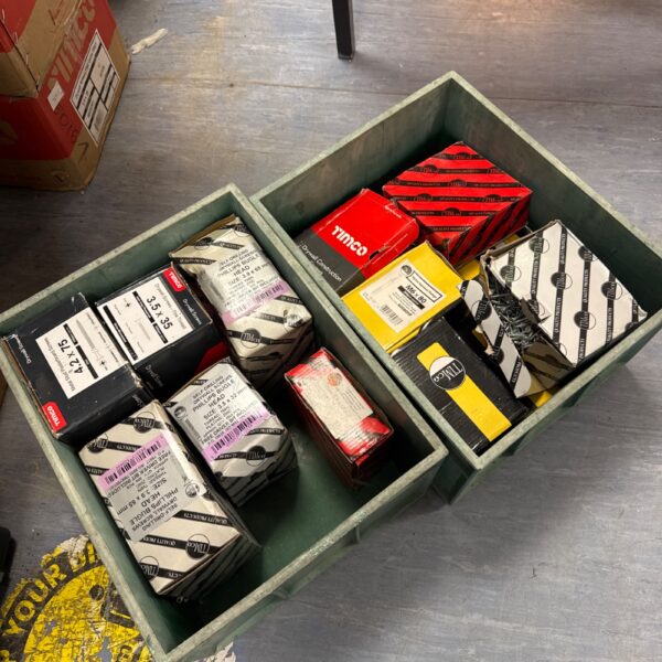 Two crates filled with assorted screws and hardware.