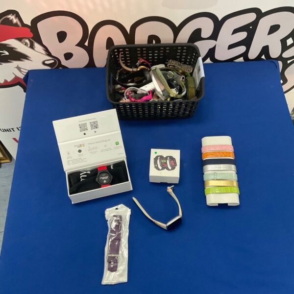 Assorted wristwatches and MyZone fitness tracker in a basket.