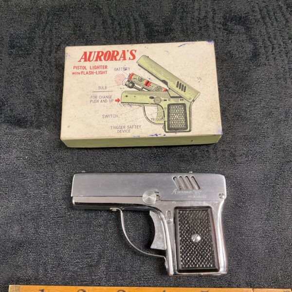 Vintage Aurora pistol lighter with flashlight, collectible novelty item.