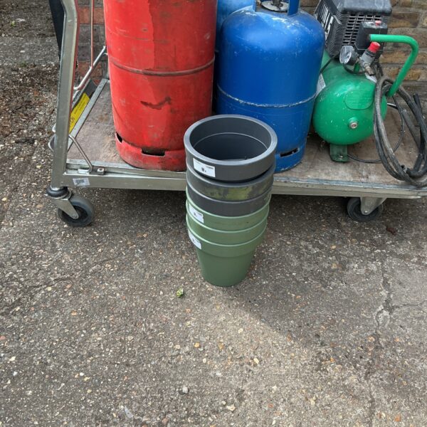 Lot of six dark plastic balcony planters for garden use.