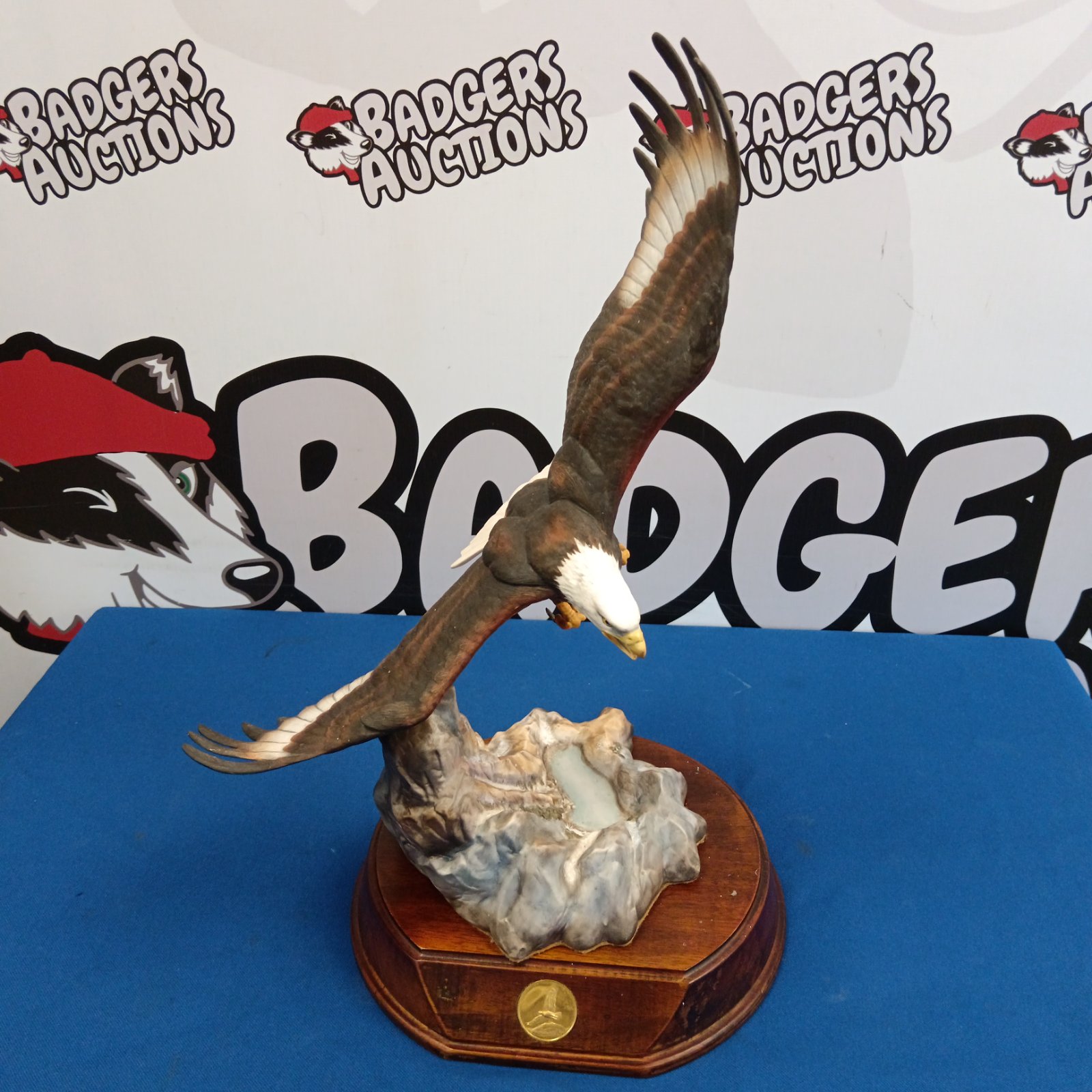 Detailed porcelain bald eagle figurine with outstretched wings.