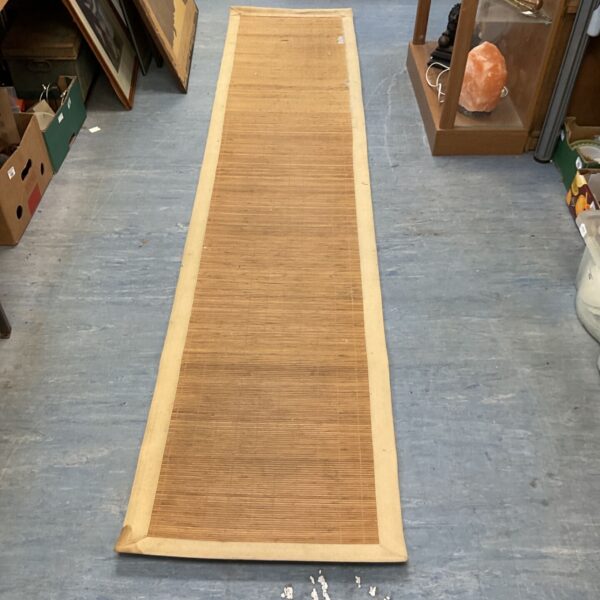 Long woven bamboo runner with a dark border.