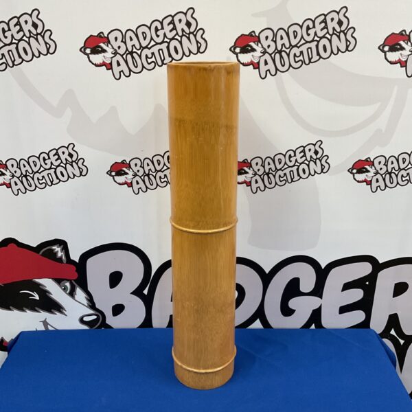 Tall bamboo stick stand for umbrellas and walking sticks.