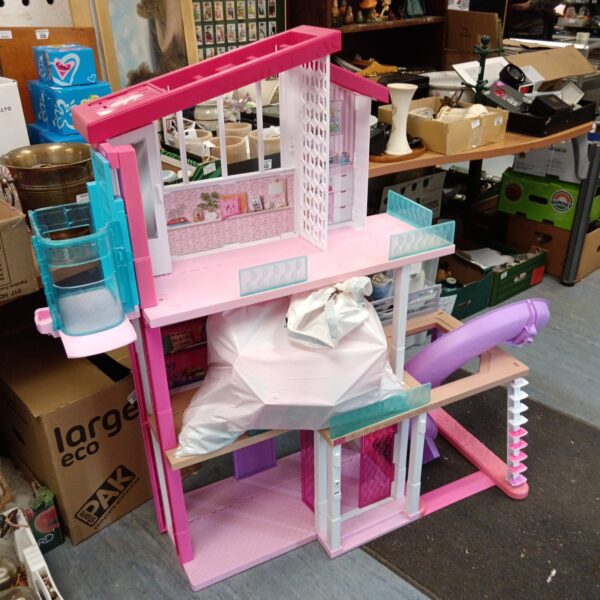 Vintage Barbie Dreamhouse with accessories, colourful dollhouse for collectors.