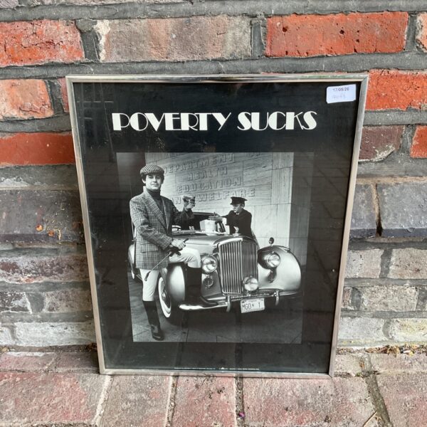 Vintage 1977 Bentley "Poverty Sucks" poster in a frame.