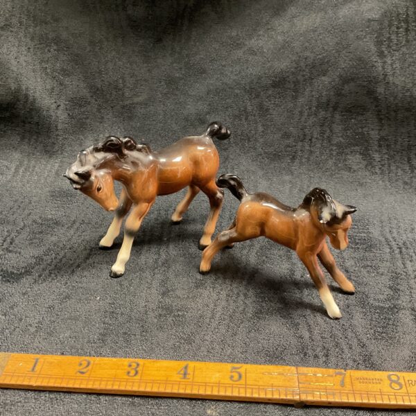 Pair of vintage Beswick ceramic foals, collectible animal figurines.