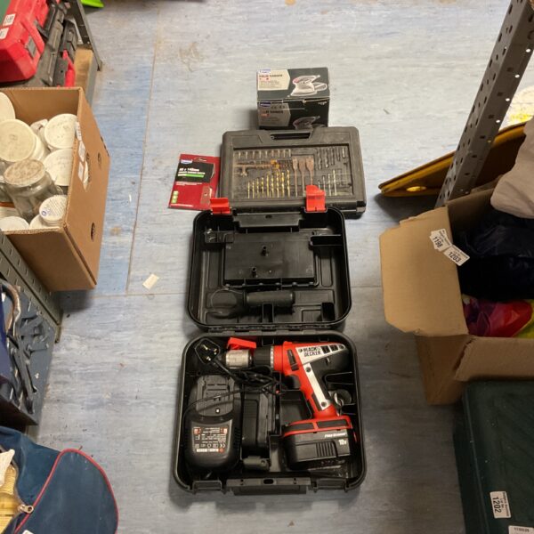 Black and Decker 18V cordless drill set with attachments and sander.