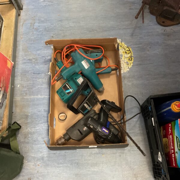 Black and Decker power tool lot including drill, sander, and trimmer.