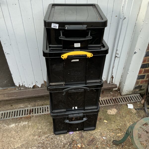 Stack of four black plastic storage boxes for household storage.