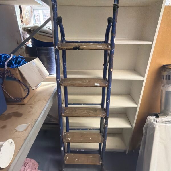 Vintage blue wooden painters ladder with four steps.