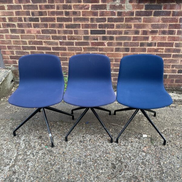 Blue upholstered swivel chairs with black bases.