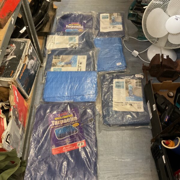 Pack of eight blue tarpaulins for weather protection.