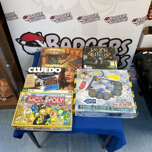 A collection of board games including Simpsons Monopoly and Cluedo.