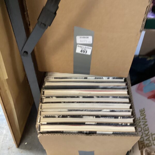 Stack of three boxes filled with mixed paperback books.