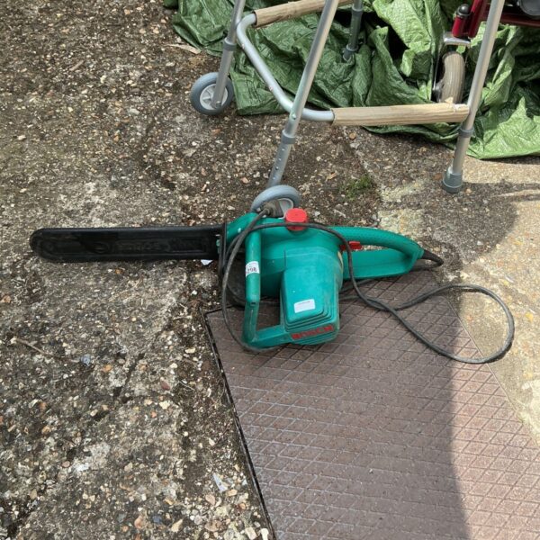 Used Bosch electric chainsaw AKE 30 S for garden and DIY tasks.