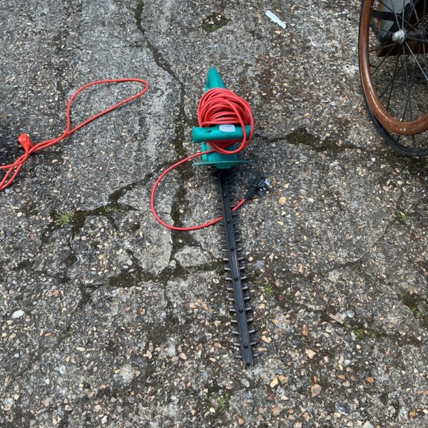 Used Bosch electric hedge trimmer for garden landscaping.