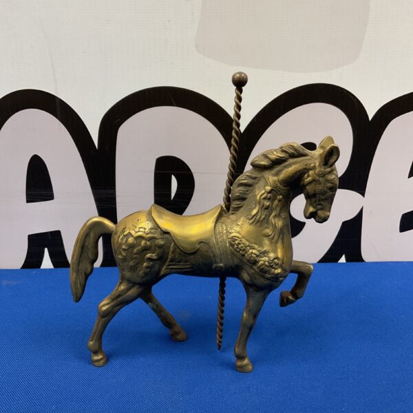 Vintage brass carousel horse ornament, detailed equestrian collectible.