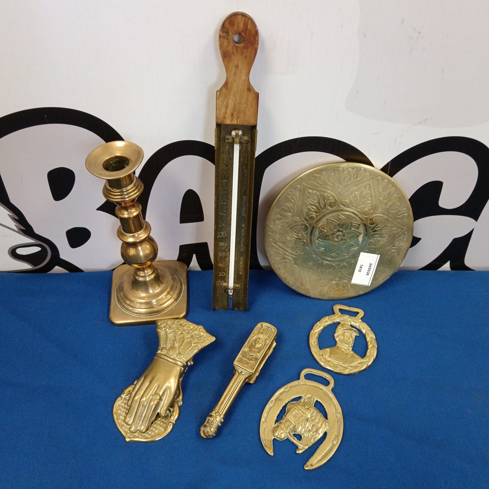 Vintage brass lot featuring candlestick, hand clip and nutcracker.