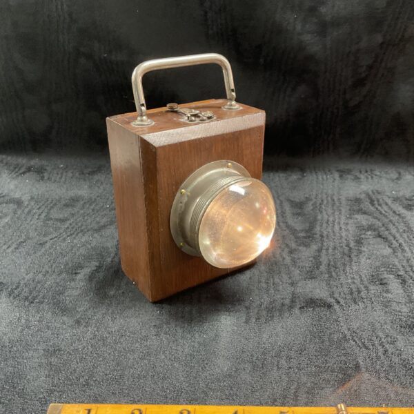 Vintage British trench torch with glass reflector and metal handle.