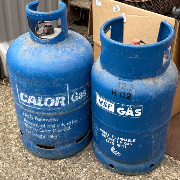 Two butane gas bottles, one branded Calor Gas, for outdoor use.