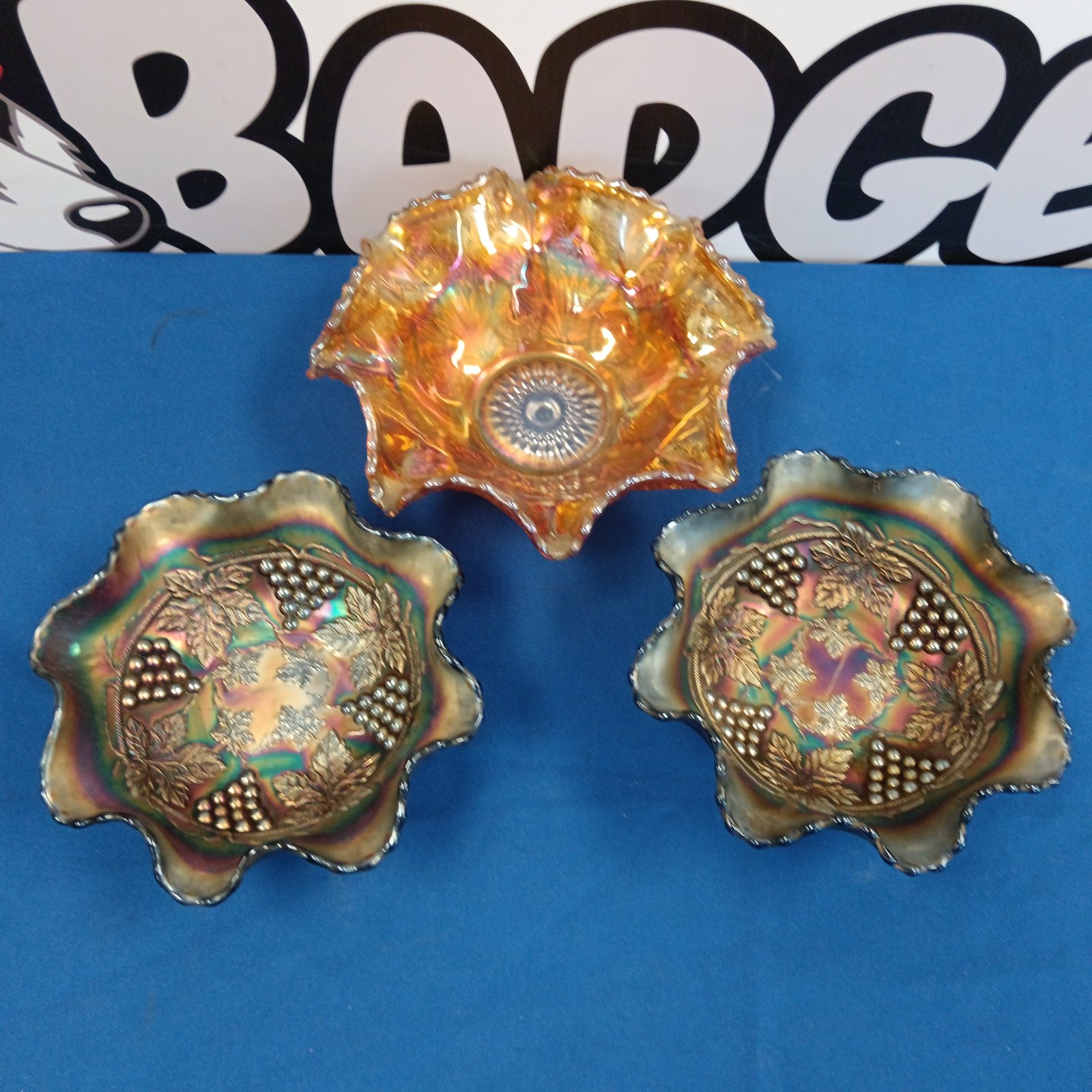 Vintage carnival glass bowls with a vibrant fruit pattern.