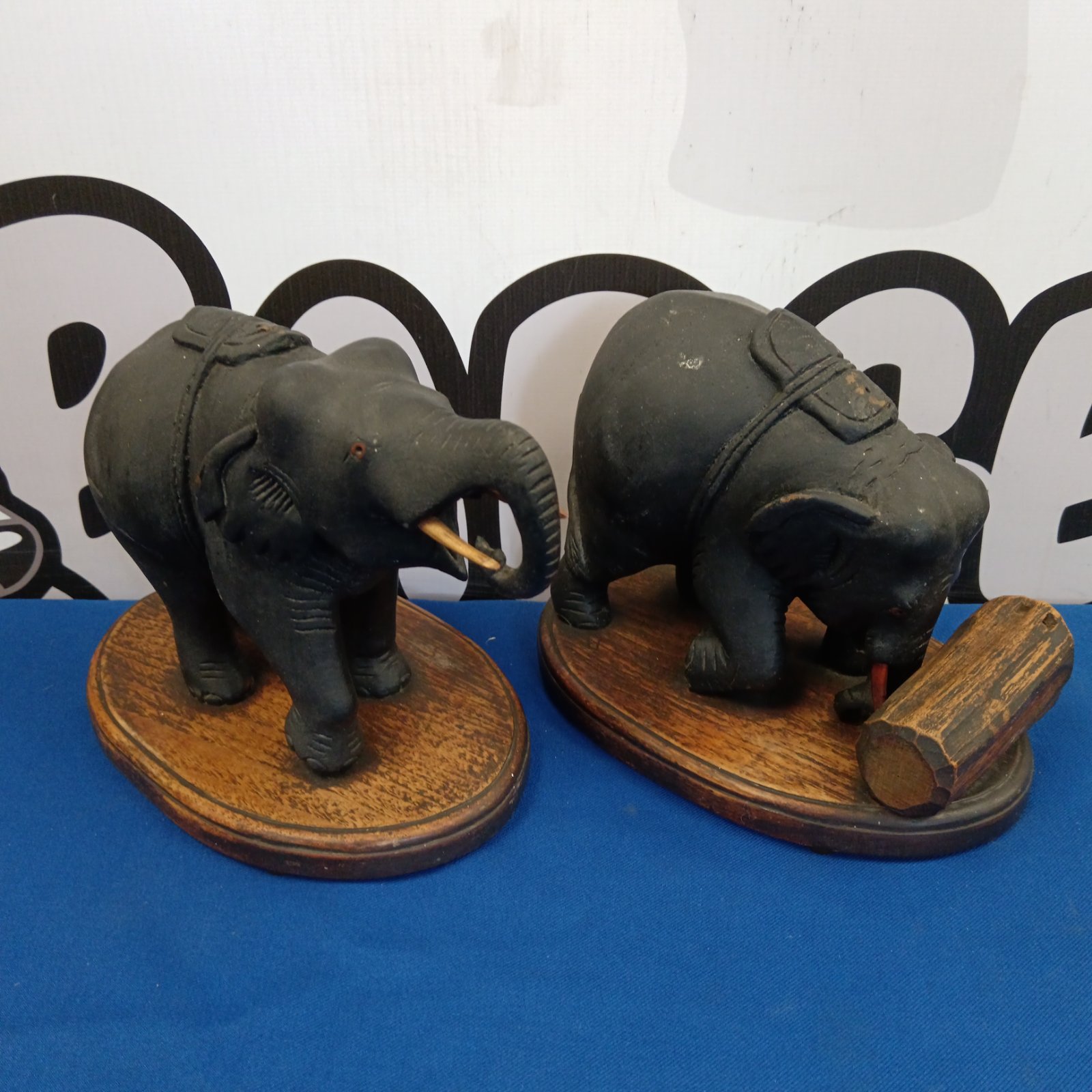 Pair of vintage carved wooden elephant ornaments on oak bases.