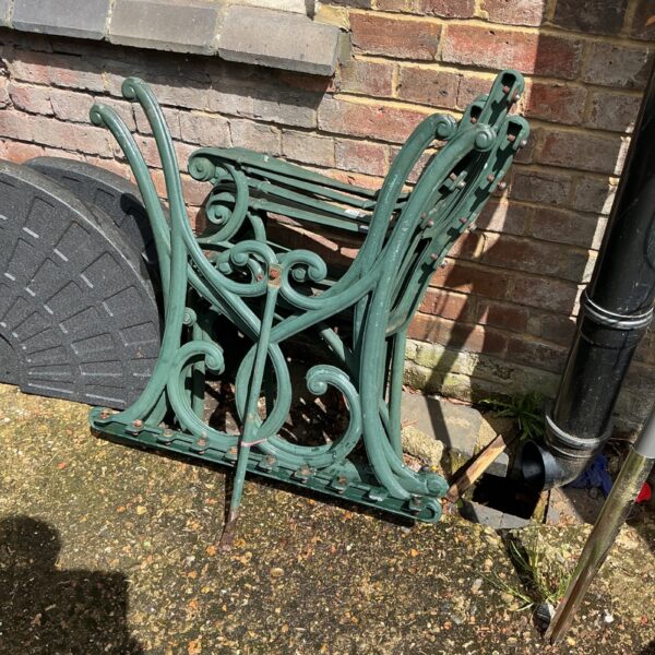 Antique cast iron bench ends with scrolling foliage design.