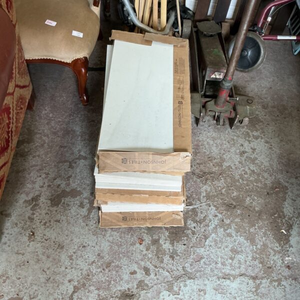 Stack of neutral ceramic wall tiles, a quantity for DIY projects.