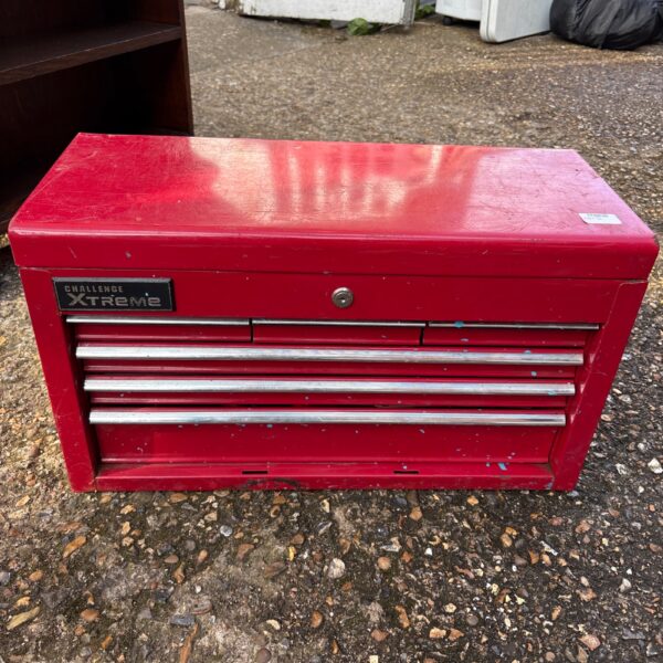 Red Challenge Xtreme toolbox with drawers, showing wear and tear.