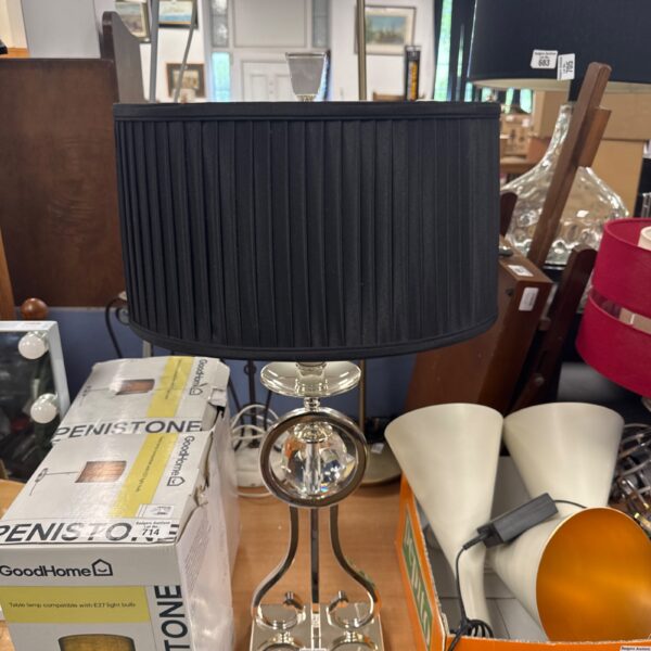 Tall chrome and crystal table lamp with navy shade.
