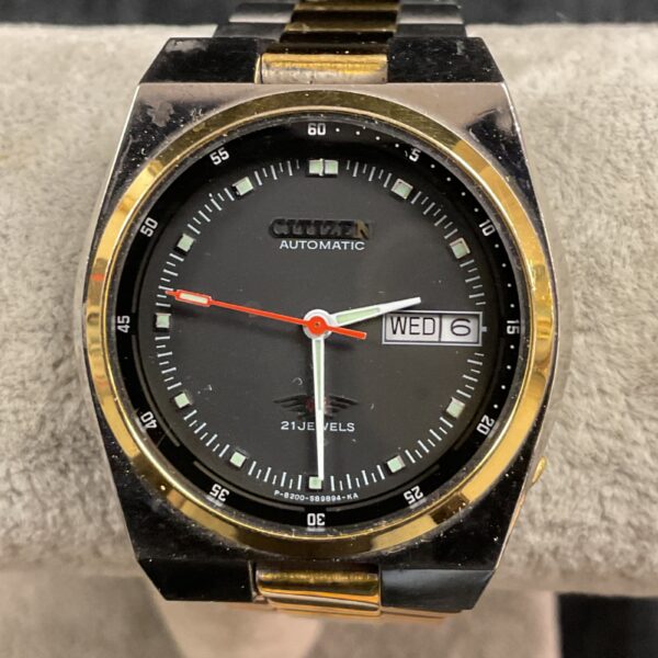 Vintage Citizen automatic wristwatch with black dial and gold accents.