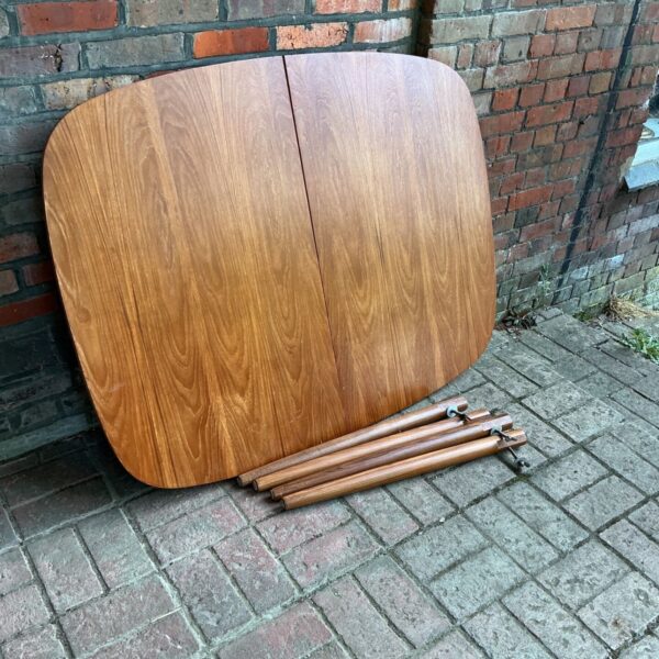 Vintage Clarke extending dining table in warm wood tone.