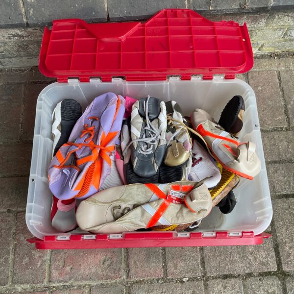 Overview of a large lot of used climbing shoes for rock climbing.