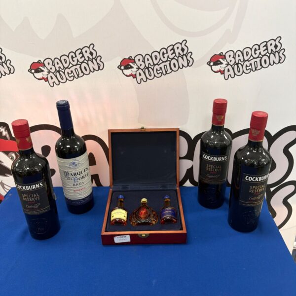 Assorted lot of Cockburn's Port, Courvoisier gift set, and Rioja wine.