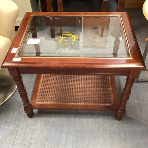 Wooden coffee table with glass top and lower shelf.