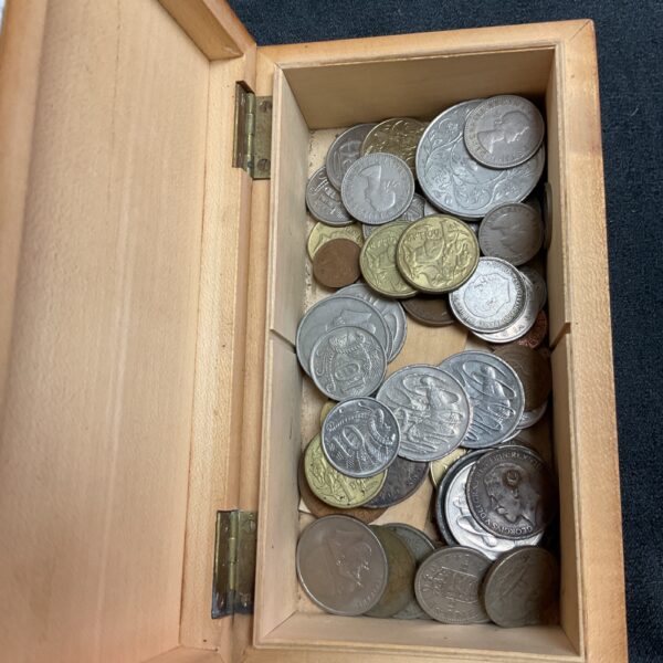 Vintage coin collection displayed in a wooden box.