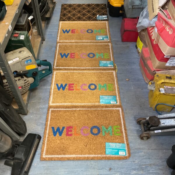 Lot of five coir doormats with welcome stencils.